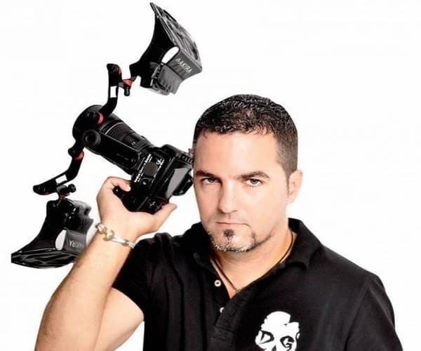 Milos Miladinov - dental photographer and educator, holding a camera rig